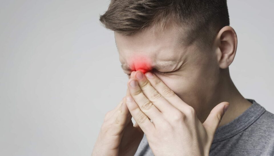 A man with a red spot on his nose, possibly related to fungal sinusitis in Burbank, CA.
