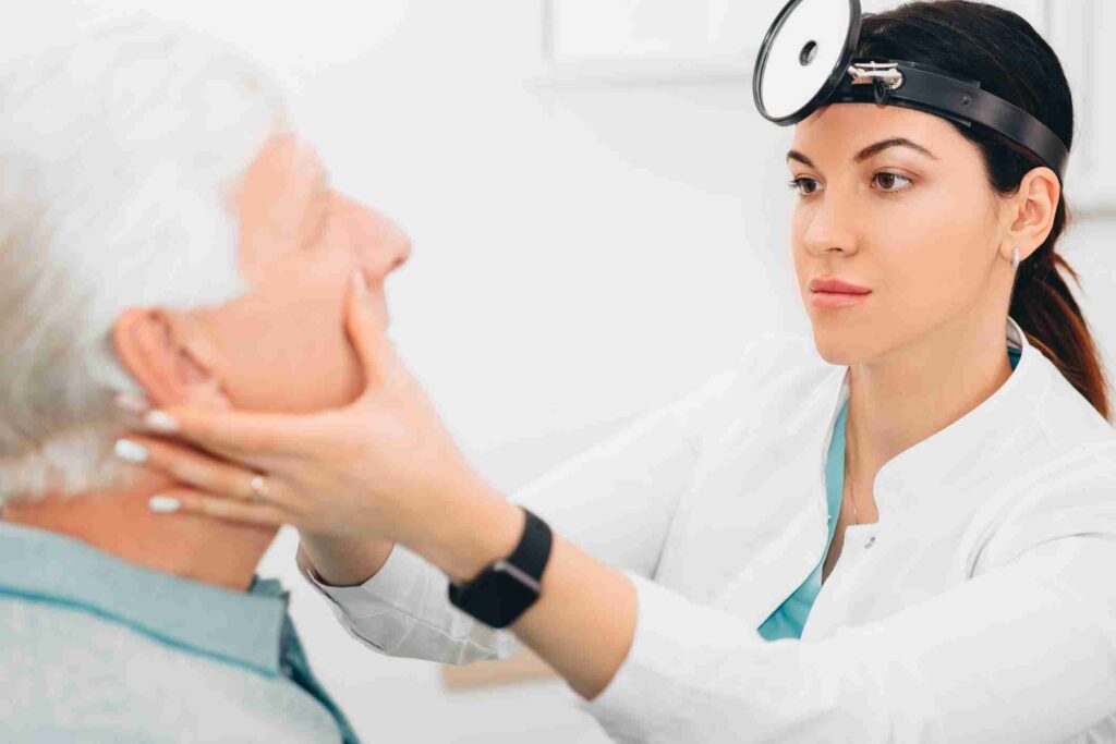 Medical professional examining elderly patient during ENT checkup in Burbank CA