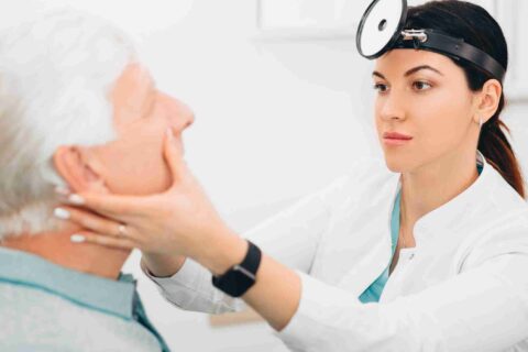 Medical professional examining elderly patient during ENT checkup in Burbank CA
