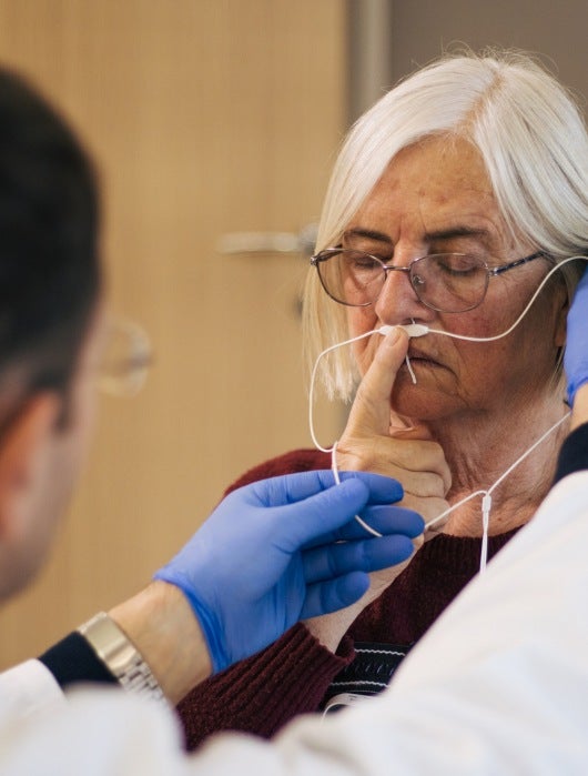 A doctor checks an elderly woman for sleep apnea in Burbank, CA